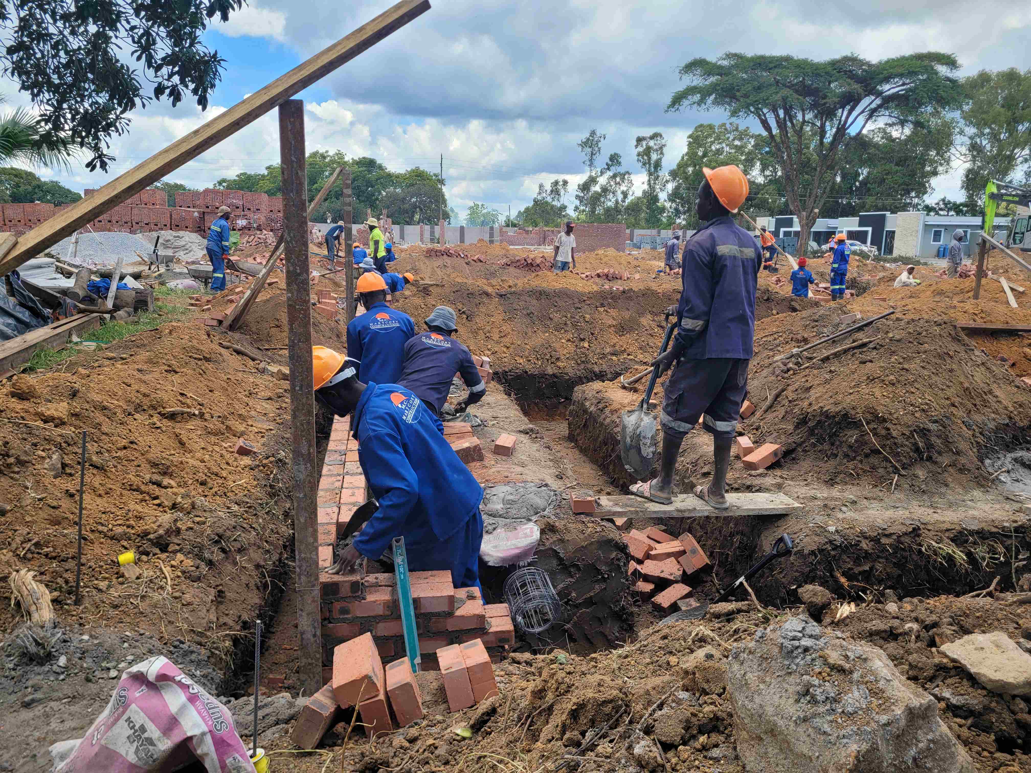 Martcosy Construction crew laying foundation trenches on a housing development